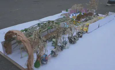 Small desktop-sized model about a 1 is to 100 scale. This model featured an arched gateway and sheltered pathway that leads to a garden-like space.